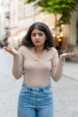 What. Why. Surprised frustrated Indian woman raising hands asking reason of failure demonstrating...