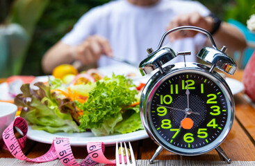 Alarm clock with IF (Intermittent Fasting) 16 and 8 diet rule and weight loss concept.-Diet plan concept