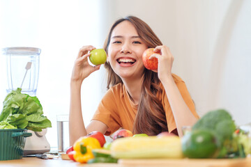Fototapeta premium portrait smiling young woman having fun with food vegetables in the kitchen,healthy food,vitamin,health care,beauty,health