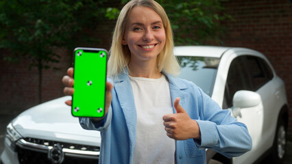 Happy Caucasian automobile owner businesswoman woman girl demonstrating mobile phone cellphone...