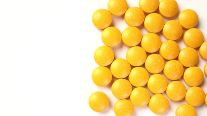 Yellow vitamins on white background.Close up and macro picture.