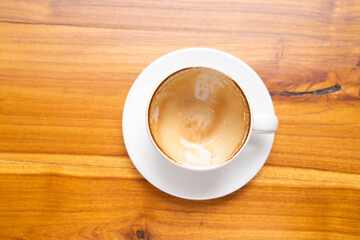 Empty coffee cup on wooden table background