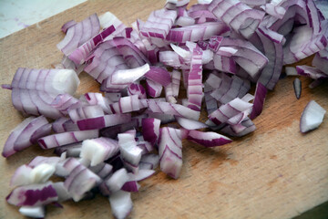 Chopped red onion on a wooden board