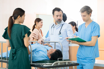 Obraz premium Professional medical team doctor give advice to relative family of senior patient after surgeon from operating room, physician specialties with stethoscope and white coat diagnose heart attack symptom