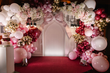 Birthday party decorations. Three-tiered cake with pink roses, Happy Birthday text topper, and gold...