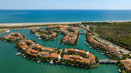 Obraz premium Aerial view of the marina of Policoro, in Basilicata, Italy. A small village with luxurious villas built between the canals.