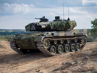 Modern Military Tank in Camouflage on Rugged Outdoor Terrain