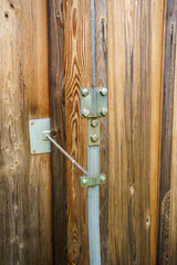 External elements of the lightning protection system on the wall of a wooden building - Place of connection of the discharge cable to the grounding system