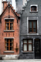 Fototapeta premium Charming brick and stone buildings blend historical architecture in a narrow European street with wooden windows and detailed facades