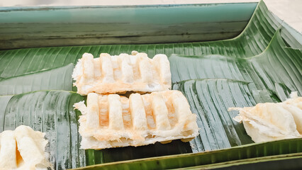 High angle view. The serving process of an authentic Indonesian traditional cake  famously known as Bandros or Gandos. Best served with crystal sugar
