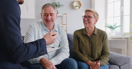 Happy spouses, mature family couple of clients consulting legal expert, lawyer, solicitor at home, asking advice, question, talking, celebrating deal, house or medical insurance buying, helping