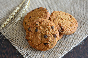 Delicious Oatmeal Cookies isolated on burlap background close up