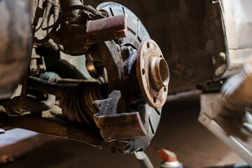 Detailed Close-Up of an Automotive Brake Assembly in a Garage Setting