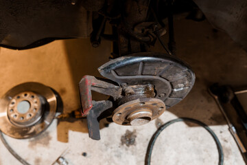 Detailed Close-Up of Automotive Brake System Components in a Workshop Setting
