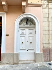 Fototapeta premium Maltese door, a striking feature of the island's architecture, with a semi-circular arch at the top, giving a sense of elegance. Mediterranean charm. January 5, 2022. Triq Gùze Cardona, Sliema, Malta