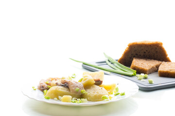 Traditional dinner - potatoes and herring, isolated on white background