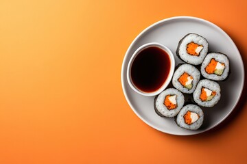 Delicious sushi rolls arranged on plate, accompanied by dipping