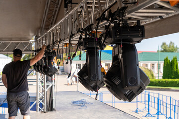 Installation of lighting equipment on a mobile concert stage.