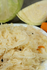 Sauerkraut salad traditional recipe consisting of cabbage, carrots, salt and peppercorns.
