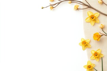 Vibrant yellow flowers arranged on a light fabric background, evoking springtime freshness and beauty