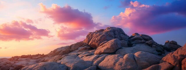 Dramatic sunset over textured rock formation with vibrant clouds and ample copy space for nature-inspired text or branding.