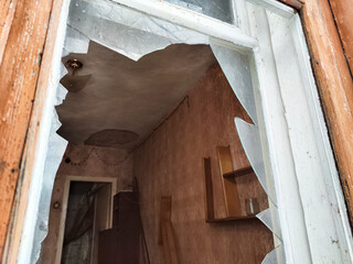 Broken glass in an abandoned building reveals a neglected interior space