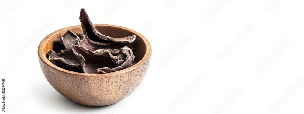 Poster dried edible fungus in wooden bowl on white background with ample space for culinary or product text