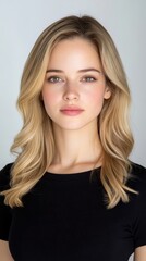 Naklejka premium Stunning Portrait of a Young Woman with Long Blonde Hair and Natural Makeup against a Light Background, Perfect for Beauty and Fashion Themes