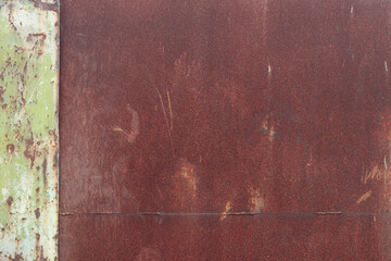 Old rusty metal surface with peeling paint and dirty streaks from rain. Cracked paint texture....