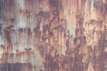 Old rusty metal surface with peeling paint and dirty streaks from rain. Cracked paint texture. Background, texture. Corrosion of iron with streaks of rust. Peeling paint on rusty and old metal