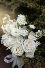 beautiful bridal bouquet of white roses on green background	