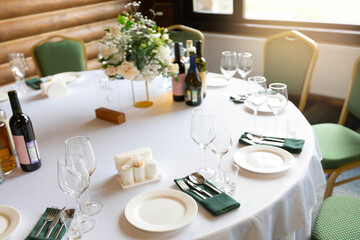 decorated round table with tablecloth in restaurant at banquet	
