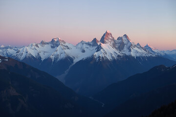 Fototapeta premium Snowy mountain range glowing at sunrise