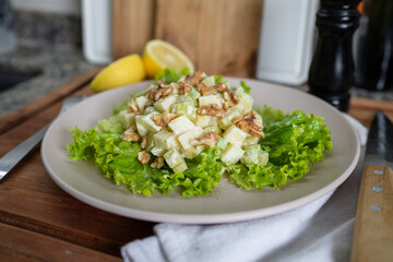 Close up shot of Waldorf salad with apple, walnuts and celery.