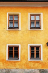 Fototapeta premium Yellow building with 3 windows and fire hydrant