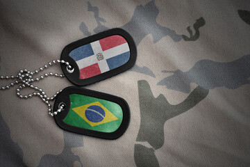 vintage army blank, dog tag with flag of dominican republic and brazil on the khaki texture...