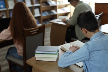 Students studying at desks in public library