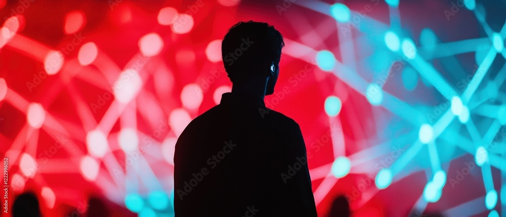 Poster person standing in front of vibrant abstract light display symbolizing technology, innovation, and d
