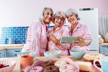 Beautiful senior women having funny pajama party at home