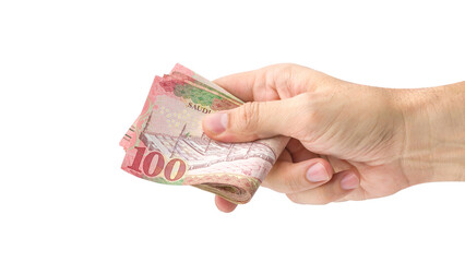 Hand-holding Saudi banknotes isolated on a white background..