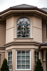 Obraz premium Elegant Home Exterior with Classic Architecture and Bay Window. Luxury Real Estate, Modern Design, Residential Property