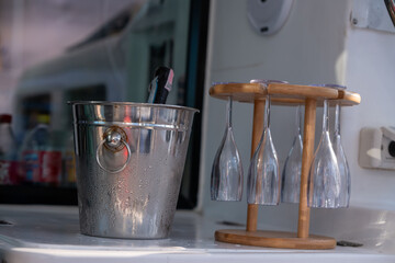 Close-up scene on a yacht or boat, featuring a stainless steel ice bucket indicating that it...