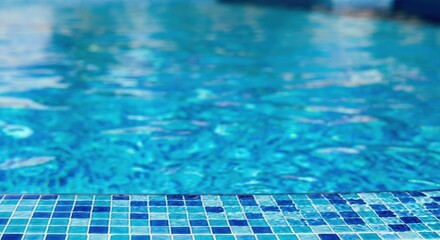 Obraz premium Tranquil blue swimming pool with shimmering water and mosaic tiles