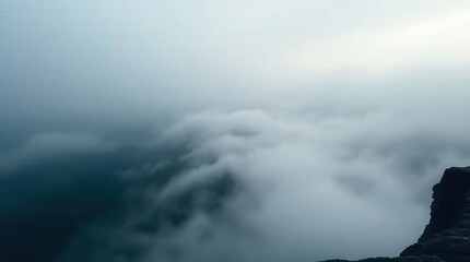 Fototapeta premium Misty Mountain Landscape with Low Clouds and Dramatic Atmosphere