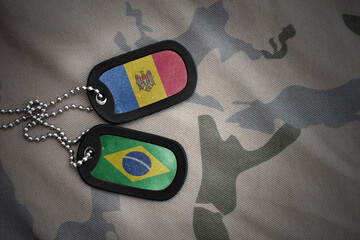vintage army blank, dog tag with flag of moldova and brazil on the khaki texture background....