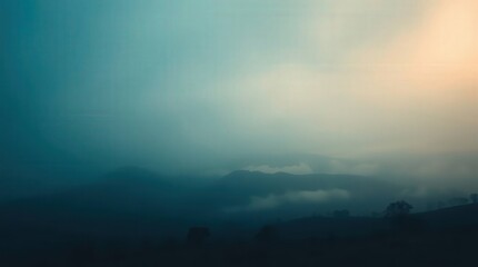 Fototapeta premium Serene Landscape with Layered Mountains and Misty Atmosphere at Dusk