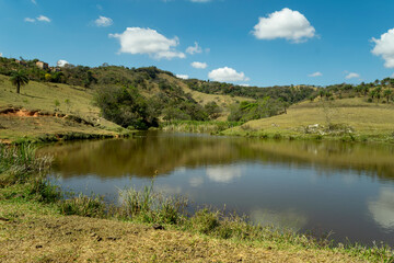 Beautiful lake, with lots of vegetation around, located in a mountainous region of the Jardim das Oliveiras neighborhood, municipality of Esmeraldas, Minas Gerais, Brazil.