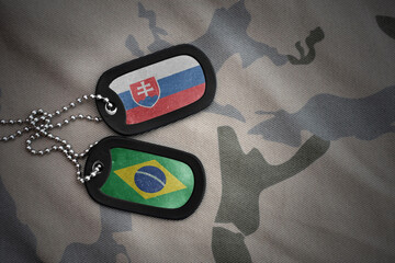 vintage army blank, dog tag with flag of slovakia and brazil on the khaki texture background....