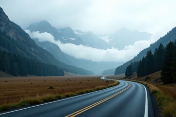 Fototapeta premium Asphalt ribbon unwinding through a misty mountain valley, leading towards a serene landscape