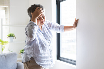 Dizzy asian elderly woman headache or migraine pain. suffering from vertigo, old standing up...